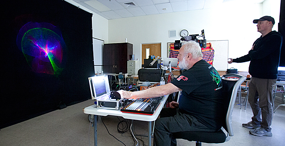 Shooting b-roll: laser lumia on the screen, Mike at the controls, Director of IT Daren Smith supervising the camera. Photo by Assistant to Line Producer Cameron Thuman.