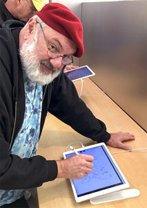 Mike Gould at the Briarwood Apple Store trying out an iPad Pro